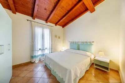 Letto o letti in una camera di Villa Salinedda