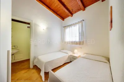 Letto o letti in una camera di Villa Salinedda