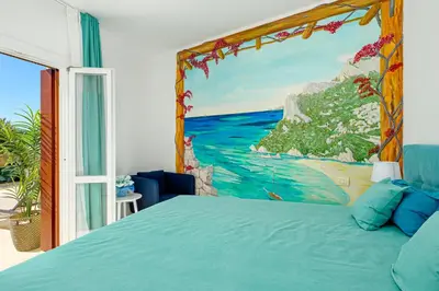 Letto o letti in una camera di Appartamento Vista Marina direttamente sulla spiaggia con vista mare