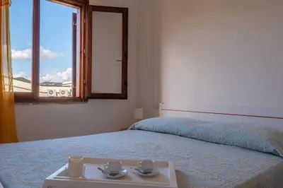 Letto o letti in una camera di San Teodoro Apartments
