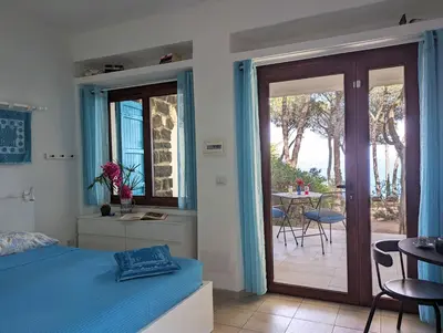 Letto o letti in una camera di Ferienzimmer Ginepro am Meer