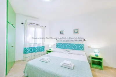 Letto o letti in una camera di Sardinia Blu Residence