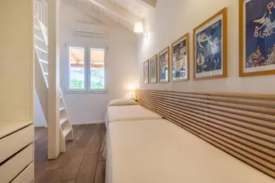 Letto o letti in una camera di Villa con accesso privato alla spiaggia di Cala Brandinchi - 8 posti letto