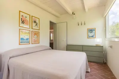 Letto o letti in una camera di Villa con accesso privato alla spiaggia di Cala Brandinchi - 8 posti letto