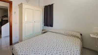 Letto o letti in una camera di La Brezza Apartment 8 posti letto San Teodoro Centro