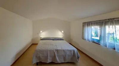 Letto o letti in una camera di DaDa House Trilocale La Suaredda di Supra San Teodoro