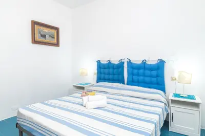 Letto o letti in una camera di Piazzetta Trilo Porto 30m From The Beach - Happy Rentals