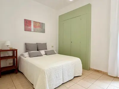 Letto o letti in una camera di Le Residenze dei Mandorli - Appartamenti immersi nel verde della macchia mediterranea a Orosei