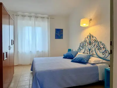 Letto o letti in una camera di Le Residenze dei Mandorli - Appartamenti immersi nel verde della macchia mediterranea a Orosei