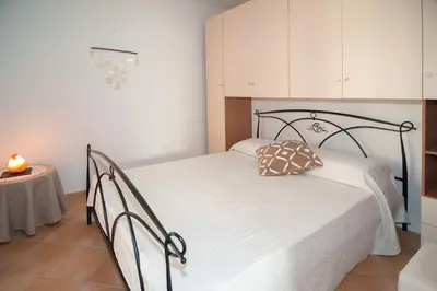 Letto o letti in una camera di Appartamento vicino alla spiaggia -B-