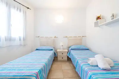 Letto o letti in una camera di Cozy veranda retreat near Budoni