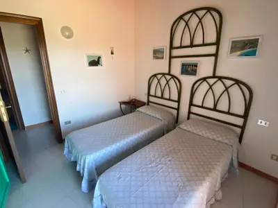 Letto o letti in una camera di Villetta Capo Coda Cavallo