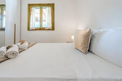 Letto o letti in una camera di 5min dalla Spiaggia La Cinta - Villetta Elegante a San Teodoro