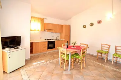 Cucina o angolo cottura di Residence with swimming pool just 5 minutes from Budoni, apartments with air conditoning and private outdoor area