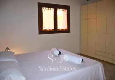 Letto o letti in una camera di San Teodoro Centro - Villetta con giardino