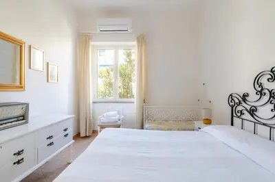 Letto o letti in una camera di Casa Colombo