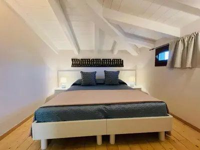 Letto o letti in una camera di Villetta Vista Mare San Teodoro Coda Cavallo