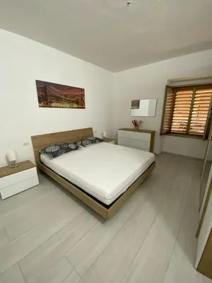Letto o letti in una camera di Appartamento SPRITZ 2 CAMERE MATRIMONIALI 7-9 POSTI LETTO