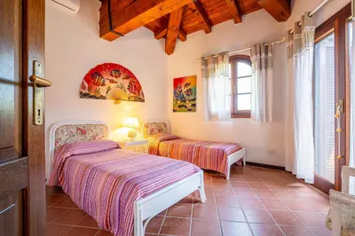 Letto o letti in una camera di Villa Silènis