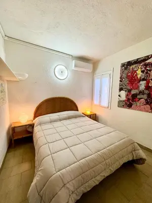 Letto o letti in una camera di Bilocale a 300mt dalla spiaggia La Cinta