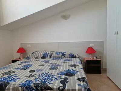 Letto o letti in una camera di Attico vista mare Caletta sul mare