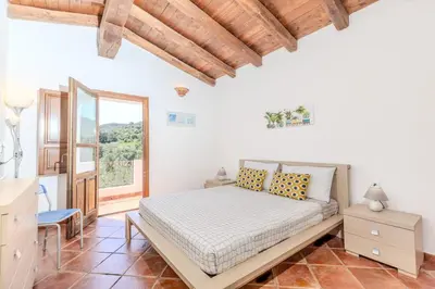 Letto o letti in una camera di Villetta Felicità SAN TEODORO