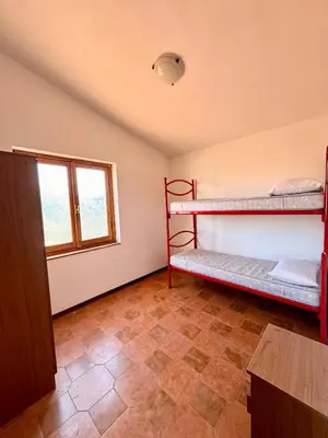 Letto o letti in una camera di Trilocale a 900mt dalla Spiaggia La Cinta