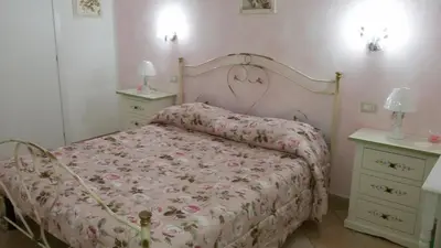 Letto o letti in una camera di B&B Le Rose