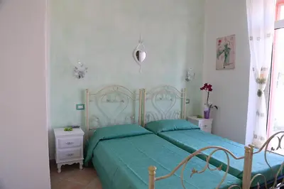 Letto o letti in una camera di B&B Le Rose