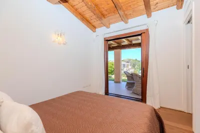 Letto o letti in una camera di Villa Capo Coda Cavallo Baia Salinedda