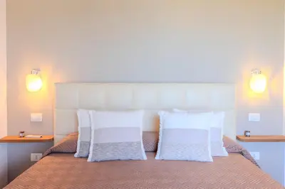 Letto o letti in una camera di Villa Capo Coda Cavallo Baia Salinedda