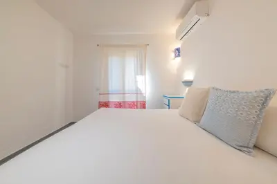 Letto o letti in una camera di NG Collection Luna di Mare