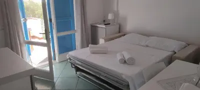 Letto o letti in una camera di SUNRISE SARDINIA San Teodoro