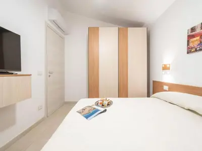 Letto o letti in una camera di San Teodoro Holiday Stay for 6