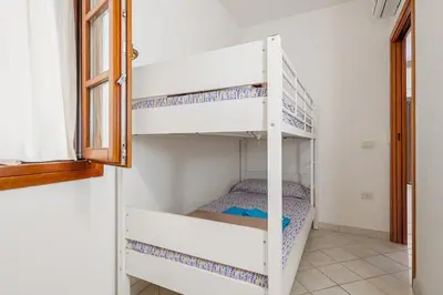 Letto o letti in una camera di Appartamento in Villetta a 800 mt dalla spiaggia