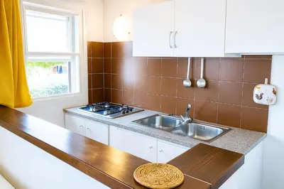 Cucina o angolo cottura di Carasau 200m from the Beach - Garden - BBQ - Wi-Fi - Parking - Pet Friendly