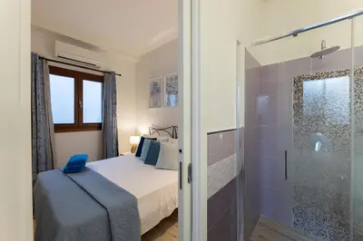 Letto o letti in una camera di Riva rooms - by Obiettivo vacanza Budoni