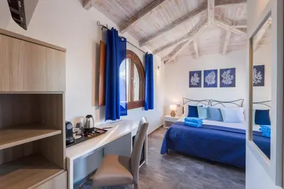 Letto o letti in una camera di Riva rooms - by Obiettivo vacanza Budoni