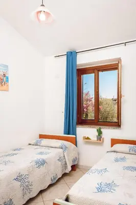 Letto o letti in una camera di VILLETTA ESCLUSIVA CON GIARDINO, San Teodoro Paradiso Terrestre