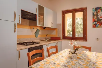 Cucina o angolo cottura di VILLETTA ESCLUSIVA CON GIARDINO, San Teodoro Paradiso Terrestre