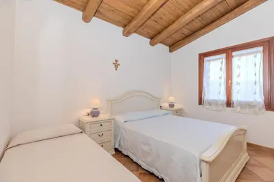Letto o letti in una camera di Splendido Stazzo vista mare San Teodoro Lu Fraili