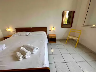 Letto o letti in una camera di Corallo Spacious place to stay steps from the sea