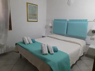 Letto o letti in una camera di ACQUAMARINA con meraviglioso giardino