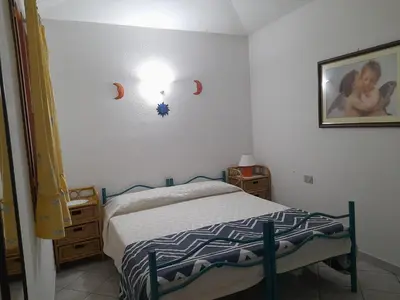 Letto o letti in una camera di ACQUAMARINA con meraviglioso giardino