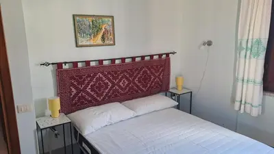 Letto o letti in una camera di Domu Joy - Appartamento - Prima Spiaggia
