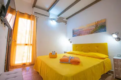 Letto o letti in una camera di B&B Sinis Domus