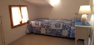 Letto o letti in una camera di Porto Coda Cavallo Loft