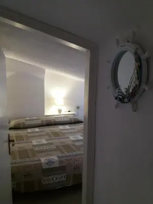 Letto o letti in una camera di Porto Coda Cavallo Loft
