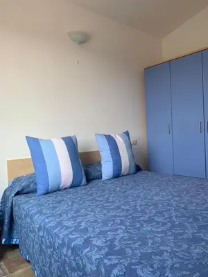 Letto o letti in una camera di Appartamento SAN TEODORO CENTRO