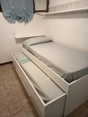 Letto o letti in una camera di I Fenicotteri Baia Caddinas
